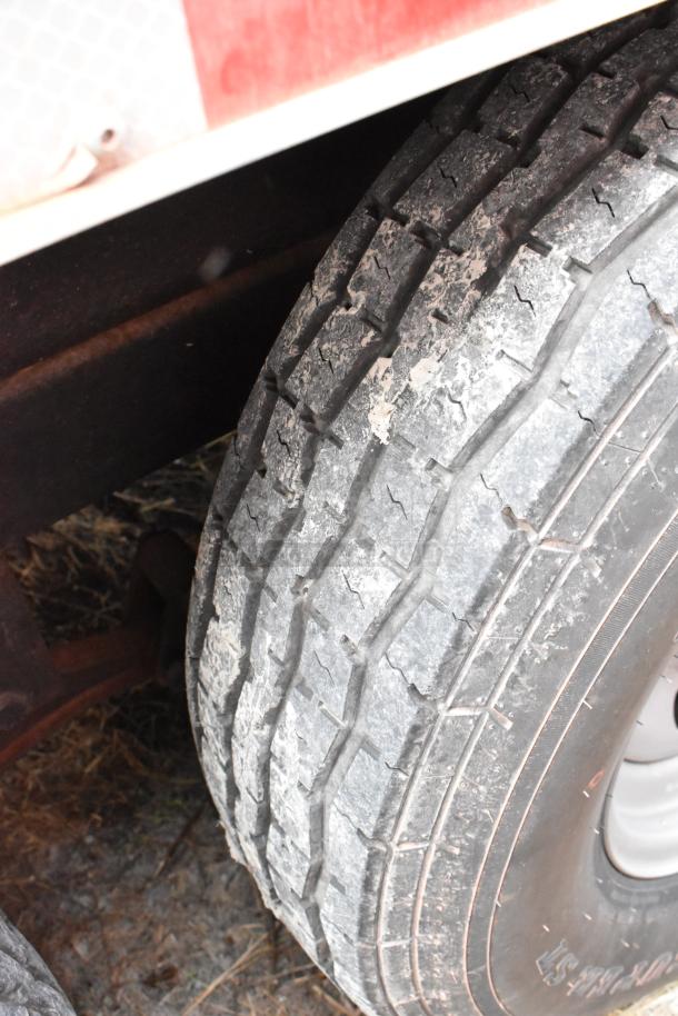 Close-up of a worn tire on a 28' Wendy's fast food trailer. Tread details visible.