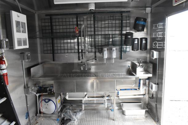 Rock Solid Cargo 24' fast food trailer interior, equipped with stainless steel sink, shelving, dispensers, and commercial-grade fixtures.
