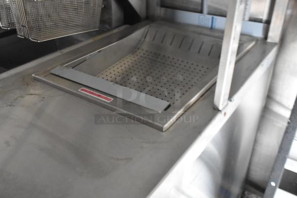 Commercial-grade dump station in a Rock Solid Cargo fast food trailer, featuring a perforated metal design, perfect for mobile kitchens.