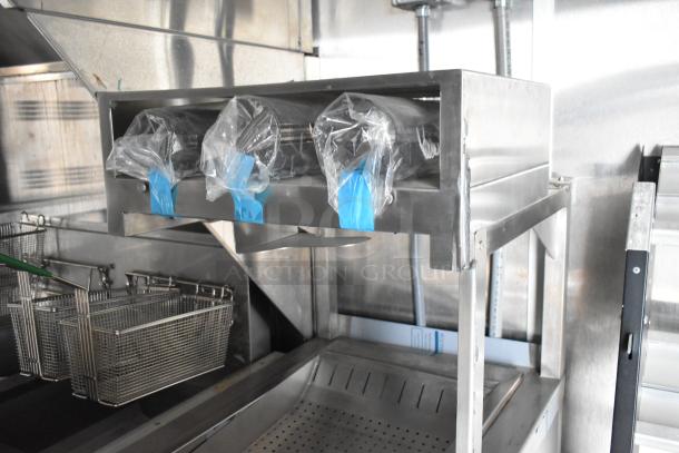 Rock Solid Cargo 24' fast food trailer interior, featuring commercial-grade fry station with baskets and stainless steel fixtures.