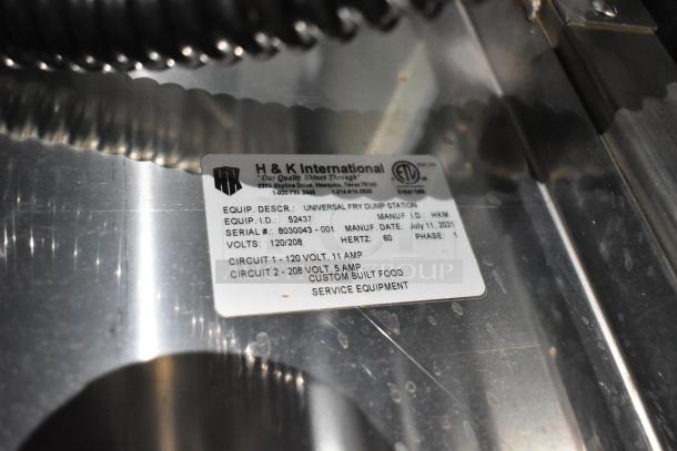 Label on H&K dump station indicates model number 52437, serial 8030043-001, voltage 120/208, manufactured July 11, 2021.