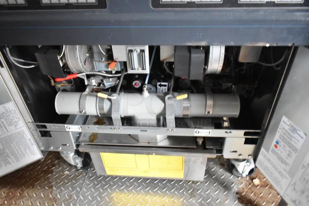Inside view of a Rock Solid Cargo fast food trailer showing part of the commercial kitchen equipment setup.