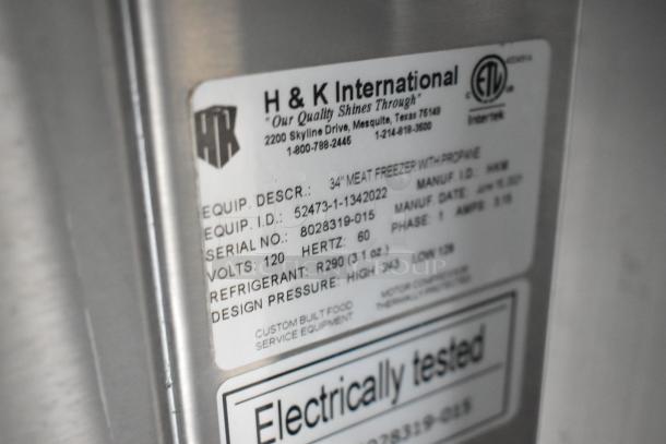 Tag on H&K International 34" meat freezer showing model, serial number, voltage, refrigerant, and testing details.
