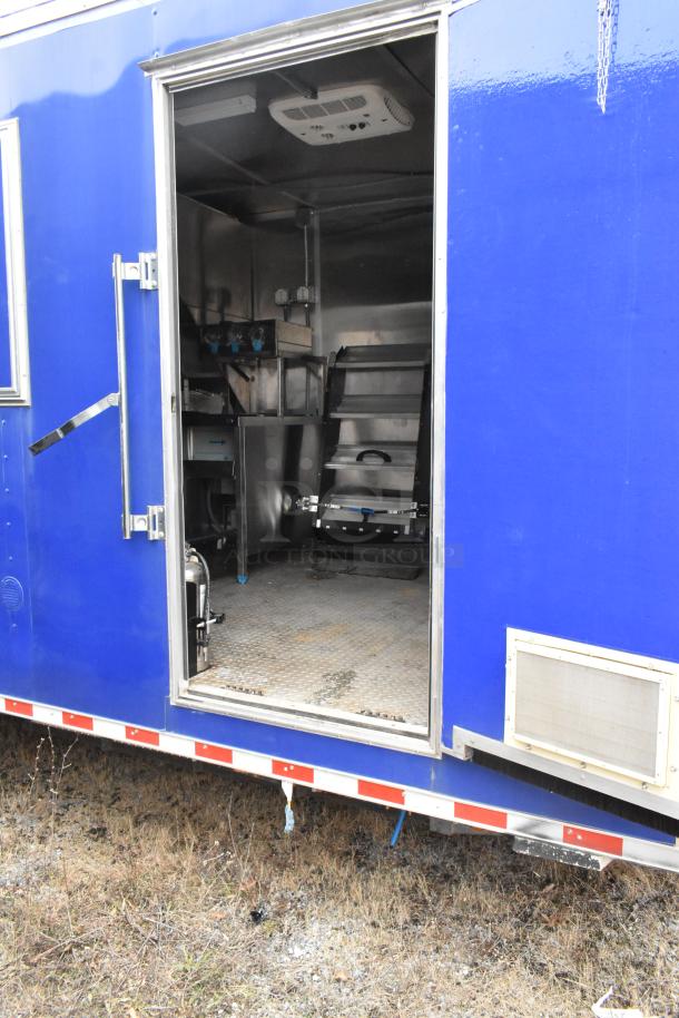 Blue 2021 Rock Solid Cargo 24' mobile kitchen trailer, featuring commercial-grade equipment inside, sold with clear title.
