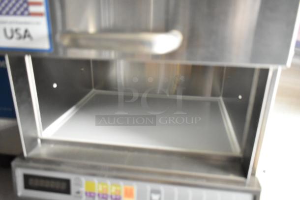 Open stainless steel commercial kitchen appliance with digital controls. Made in USA label visible.