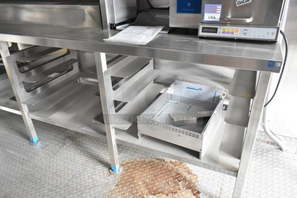 Rock Solid Cargo 24' trailer interior with stainless steel shelving and industrial equipment, condition appears lightly used.