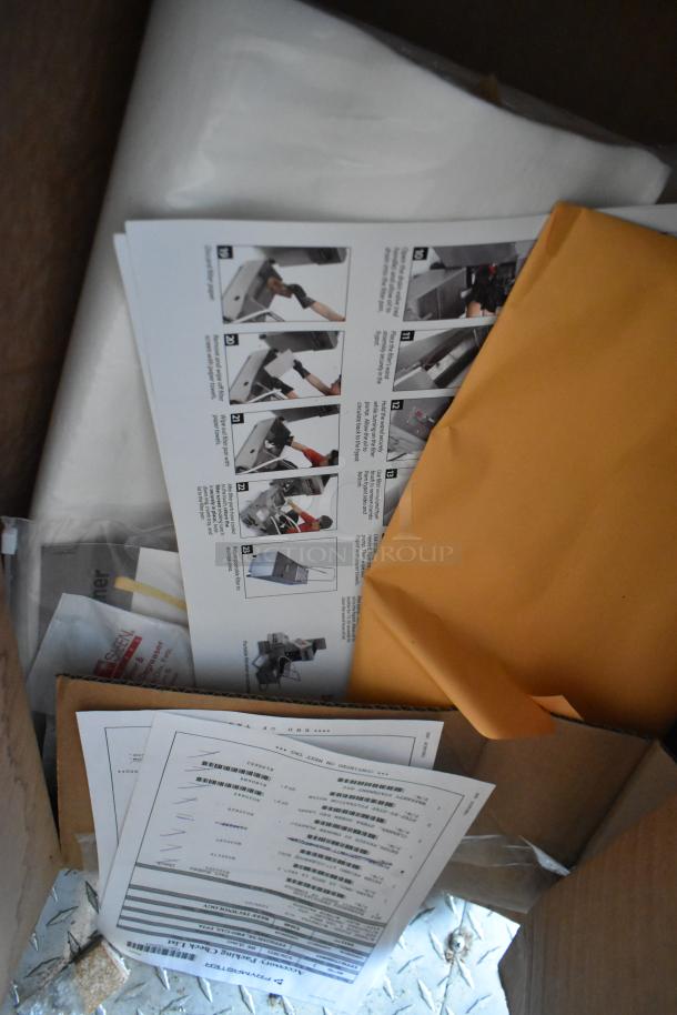 Box containing instruction manuals and documents for a Rock Solid Cargo 24' mobile kitchen trailer.