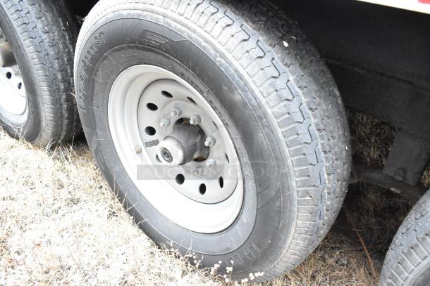 Dual tire set of a 2021 Rock Solid Cargo 24' fast food trailer. Rugged Highway Sport ST tires on metal rims.