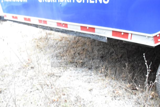 Rock Solid Cargo 24' fast food trailer exterior, partial view with blue panel and red/white trim. Ideal for mobile kitchen setup.