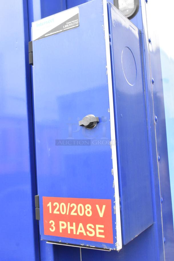 Exterior view of a Rock Solid Cargo 24' fast food trailer with a 120/208 V 3 phase label and Intersect service contacts.