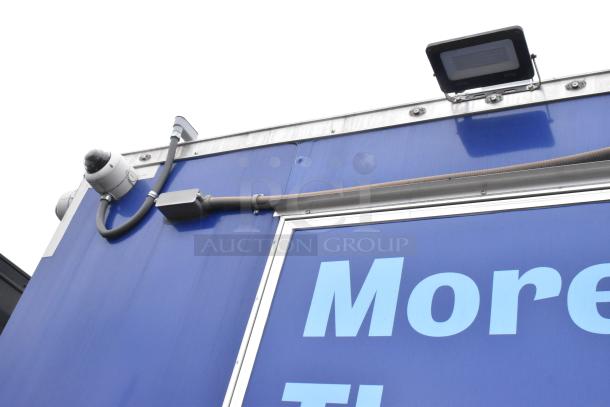 Roof corner of a Rock Solid Cargo 24' trailer with camera and lighting, part of a fully equipped mobile kitchen.