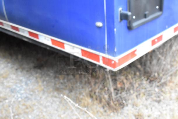 Rock Solid Cargo 24' fast food trailer, blue exterior, partially visible. Features commercial-grade equipment, ready for service.