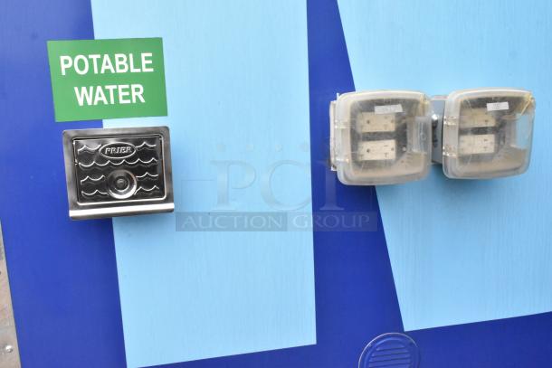 Blue trailer exterior with a "Potable Water" sign, Priera water inlet, and covered power outlets.