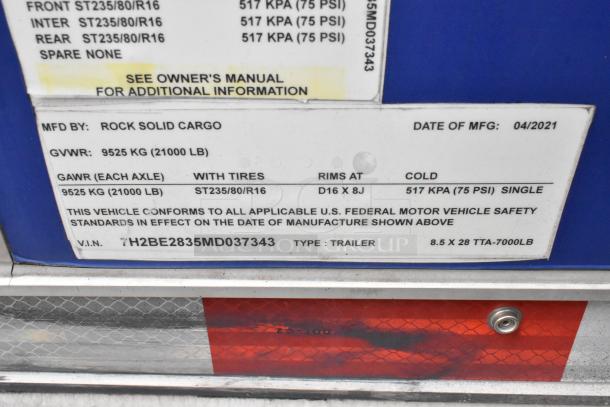 Rock Solid Cargo trailer label showing manufacturer, VIN, GVWR of 9525 kg, tire specs, and manufacturing date of April 2021.
