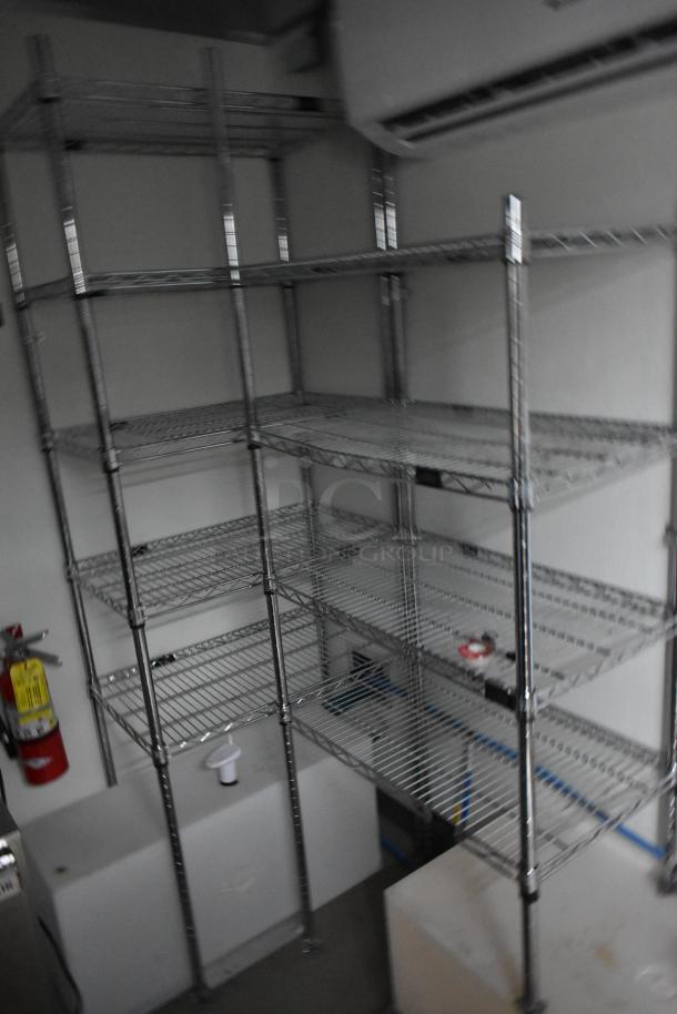 Interior of Nationwide 24' food trailer with metal shelving, Gree air conditioner, and fire extinguisher, in pristine condition.