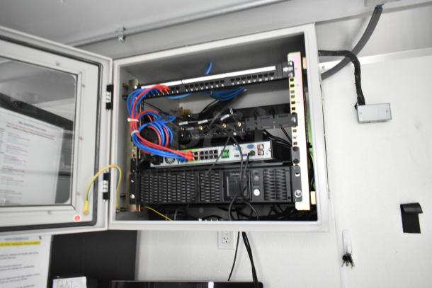 Electrical panel inside Nationwide 24' food trailer, showcasing organized wiring and network equipment setup.