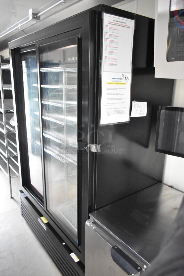 Nationwide 24' food trailer interior featuring a Beverage Air 2-door cooler merchandiser and reach-in cooler, ideal for mobile kitchens.