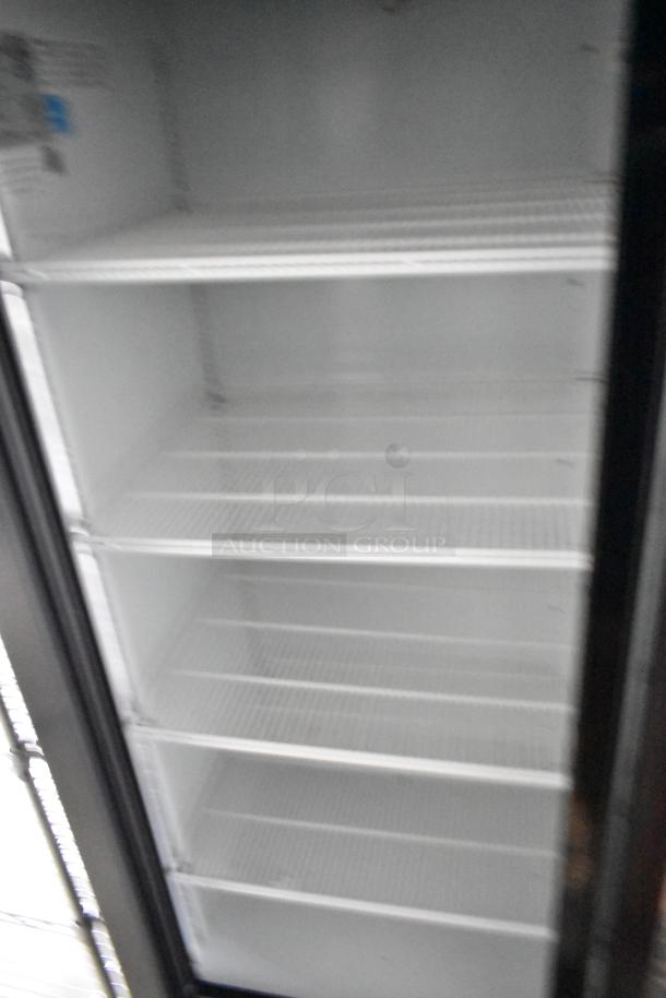 Interior view of a Beverage Air 2-door cooler merchandiser in a 24' Nationwide food trailer, with white wire shelves.