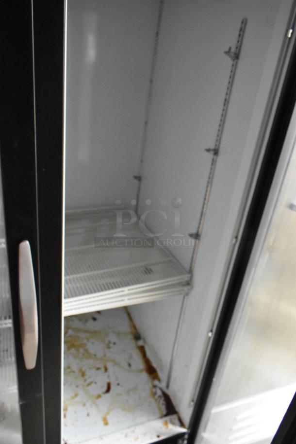 Alt text: Interior view of Beverage Air 2-door cooler inside Nationwide 24' food trailer. Shelving and stains visible.