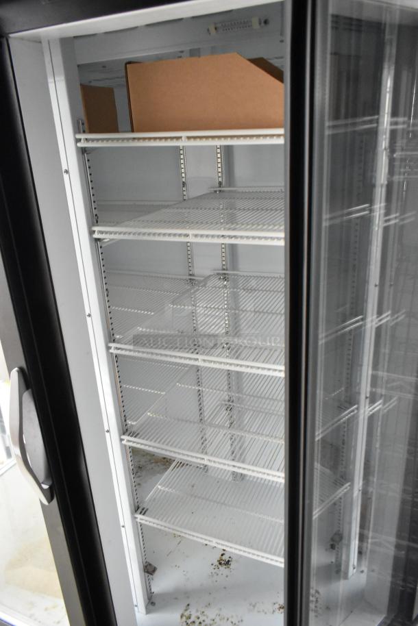 Interior view of a commercial Beverage Air 2-door cooler with white wire shelving inside a Nationwide food trailer.