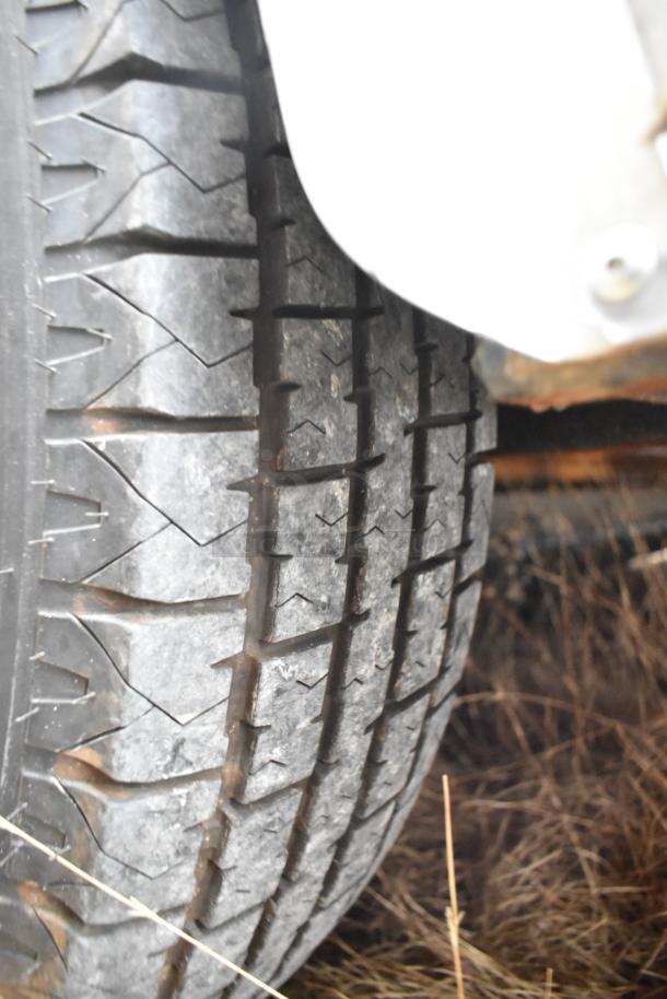 Close-up view of a tire on the Nationwide 24' food trailer, showing tread pattern and wheel condition.