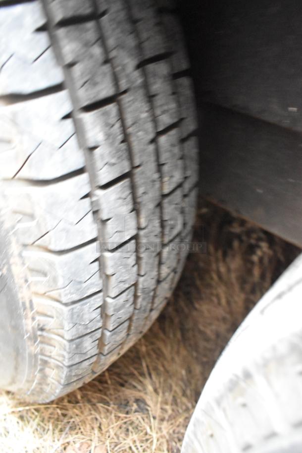 Close-up view of a tire on the Nationwide 24' food trailer, highlighting tread condition and durability.