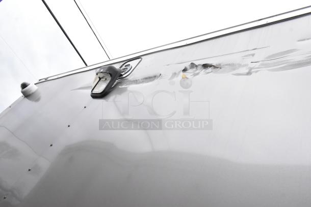 Exterior view of a Nationwide 24' food trailer with visible dent and security camera on the roof.