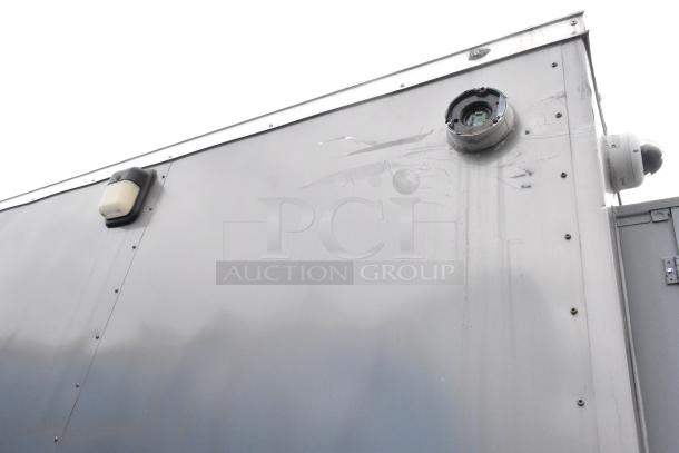 Exterior close-up of a Nationwide 24' food trailer showing the metal siding and a roof fixture, highlighting sturdy construction.