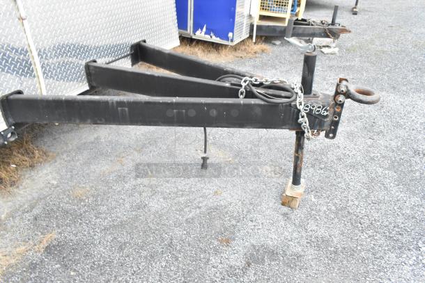 Trailer hitch of Nationwide 24' food trailer, showing metal components and chains. Suitable for mobile kitchen setup.
