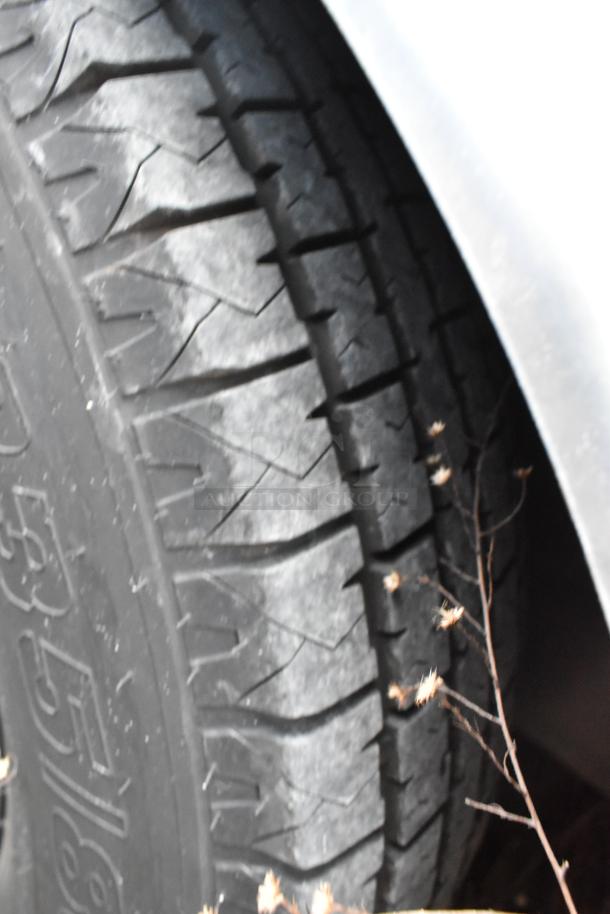 Close-up of a tire with detailed tread pattern, likely part of the Nationwide 24' fully outfitted food trailer.
