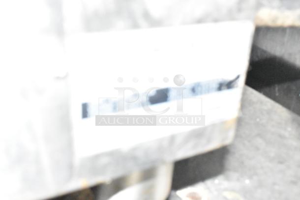 Blurry image of a label on a Stuff4less fast food trailer, unclear details due to focus.