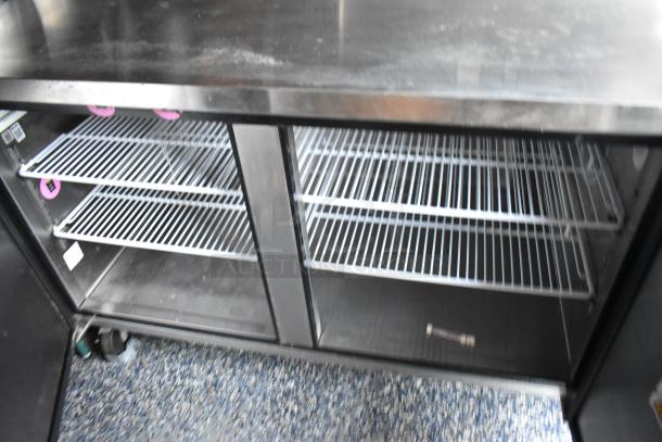 Interior view of Stuff4less mobile kitchen trailer with stainless steel shelving, showcasing part of the Atosa equipment setup.