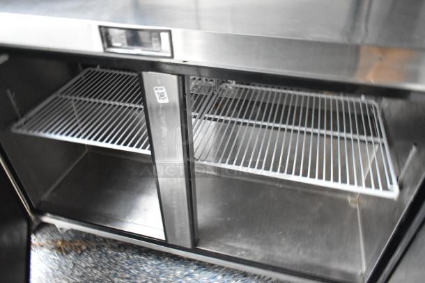 Commercial-grade stainless steel cooler interior with two wire shelves, part of a fully equipped Stuff4less food trailer.