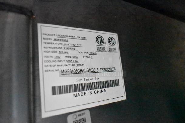 Label on a Stuff4less undercounter freezer, model MGF8406GR, showing specs like temperature range and refrigerant type.