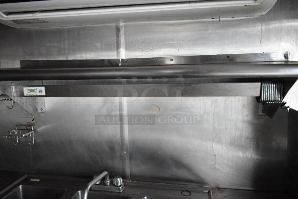 Interior view of a 2019 Stuff4less 24' food trailer with stainless steel walls, sinks, and an air conditioner. Clear title included.