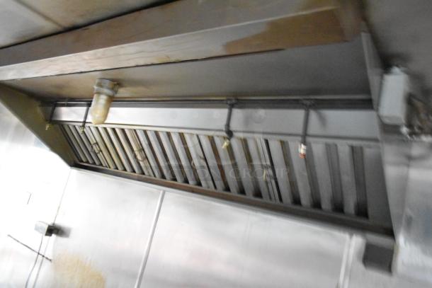 Interior view of Stuff4less 24' food trailer hood vent. Stainless steel, equipped with lighting and fire suppression nozzles.