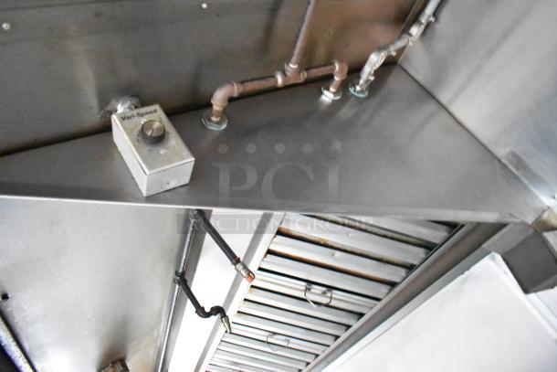 Interior view of a Stuff4less 24' unbranded shell food trailer showing metallic vent and pipes. Features visible control labeled "Var-Speed".