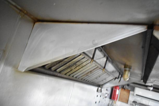 Interior view of a 2019 Stuff4less 24' unbranded shell food trailer, featuring a ventilation hood and air conditioner. Ready for outfitting.