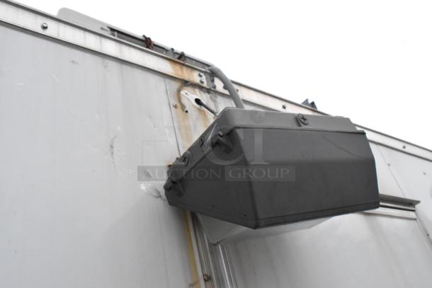 Close-up of a 2019 Stuff4less 24' unbranded shell food trailer exterior, showing a mounted utility box. Ready for kitchen outfitting.