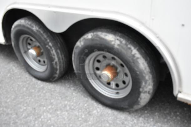 Dual wheel axles of a 2019 Stuff4less 24' unbranded food trailer. Ready for customization. Sold with a clear title.