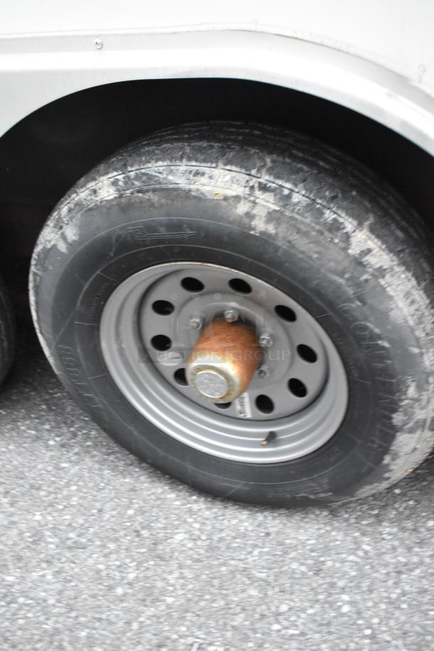 Close-up of the wheel on a 24' Stuff4less unbranded shell food trailer, new in 2019, ready to be outfitted.