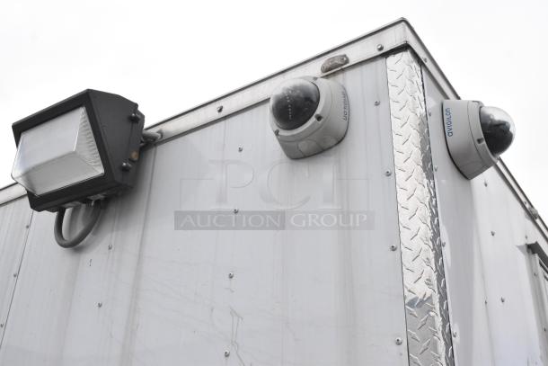 Exterior detail of a 2019 Stuff4less 24' unbranded food trailer. Features mounted security cameras and exterior light. Clear title.