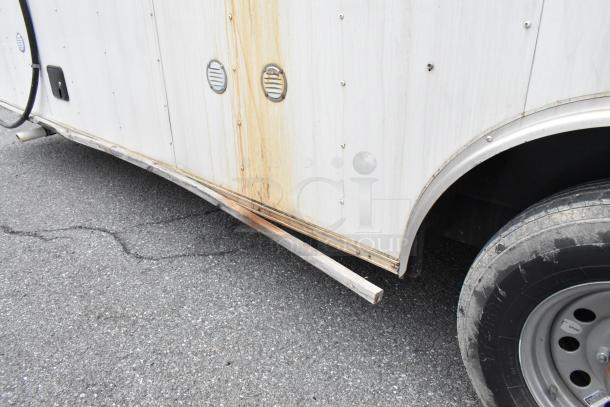 Stuff4less 24' shell food trailer, unbranded, 2019 model. Exterior detail with air vents, rust marks. Ready to outfit.