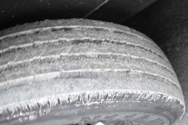 Image of a worn tire on the SDG 20' unbranded shell food trailer, showing tire condition and tread wear, indicative of usage.