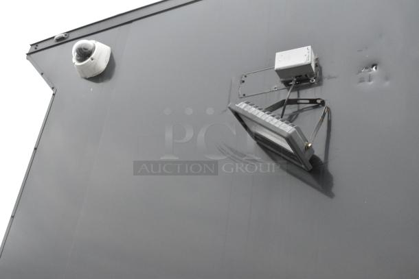 Exterior view of a 2020 SDG 20' unbranded shell food trailer. Features a mounted security camera and floodlight.