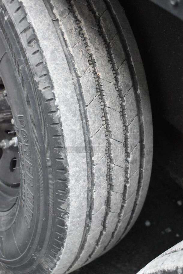 Close-up of a tire on a 2020 SDG 20' unbranded shell food trailer, showing tread detail and sidewall markings.