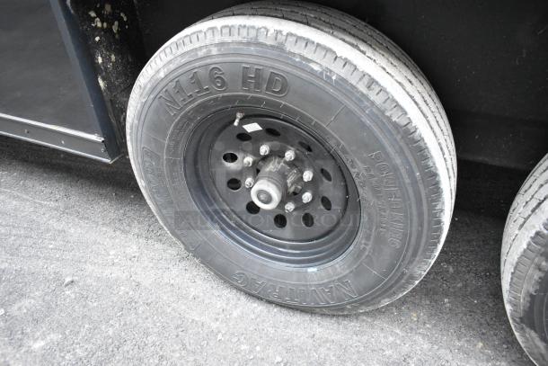 Close-up of a black trailer wheel with "N.16 HD" and "Power King" markings. Part of a 2020 SDG 20' food trailer.