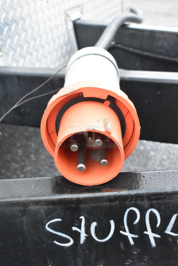 Orange power connector on a mobile kitchen trailer. Visible text: "Stuff4less."