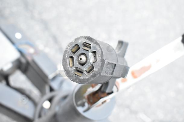 Close-up of a trailer connector on the Stuff4less 24' food trailer. Connector shows slight wear. Ready to be outfitted.