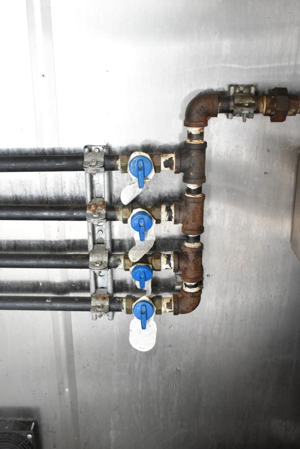 Internal plumbing system of a 2019 Stuff4less 24' food trailer, showing multiple blue valve controls for water flow management.